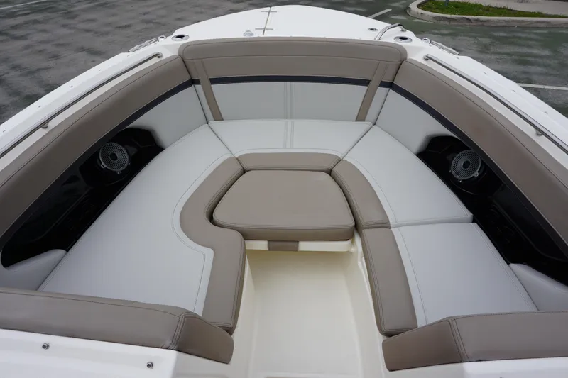 Slide: The Image of 2026 Boston Whaler 240 Vantage boat interior with cushioned seating and speakers. - 30