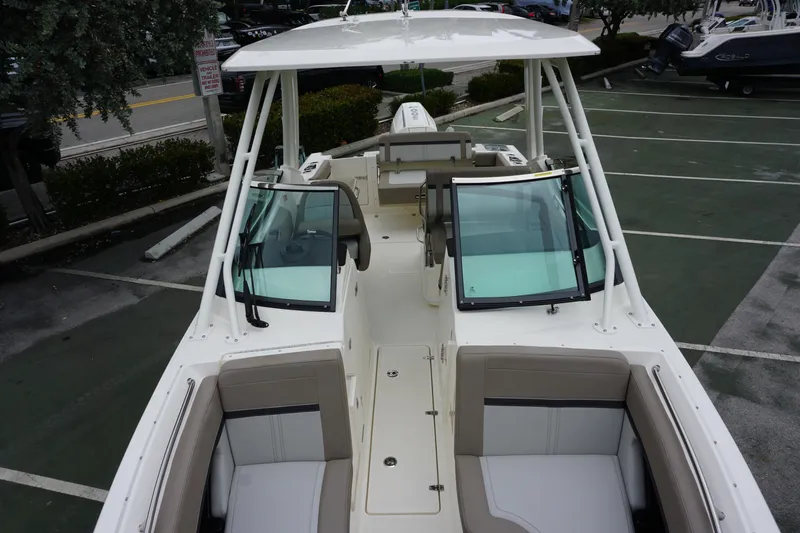 Slide: The Image of 2026 Boston Whaler 240 Vantage boat with spacious seating and modern design in a parking lot. - 32