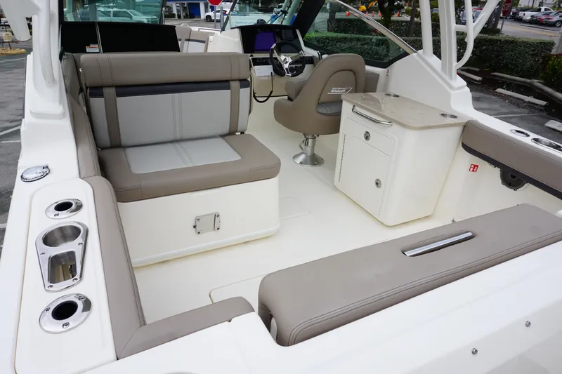 Slide: The Image of 2026 Boston Whaler 240 Vantage interior with seating, helm, and storage compartments. - 9
