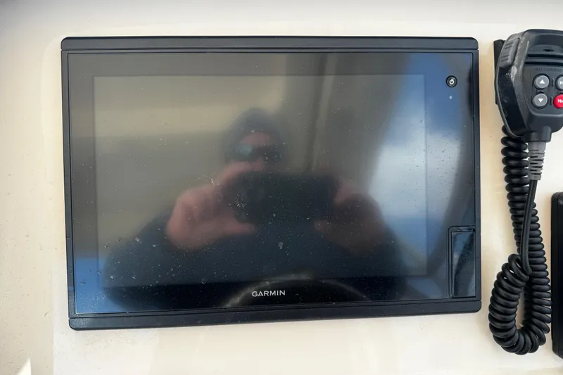 Slide: The Image of Garmin display and radio on 2019 Grady-White Freedom 275 boat dashboard. - 14