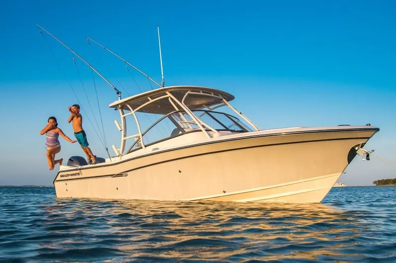 Slide: The Image of Manufacturer Provided Image: 2019 Grady-White Freedom 275 boat with people jumping into the water. - 2