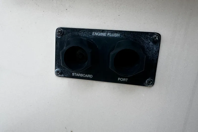 Slide: The Image of Engine flush ports on a 2019 Grady-White Freedom 275 boat, labeled starboard and port. - 22