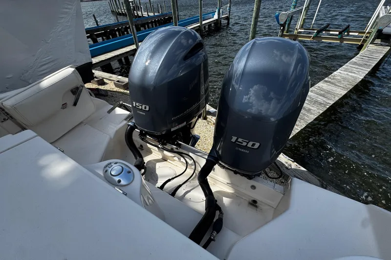 Slide: The Image of 2019 Grady-White Freedom 275 boat with twin Yamaha 150 outboard engines docked by the water. - 24