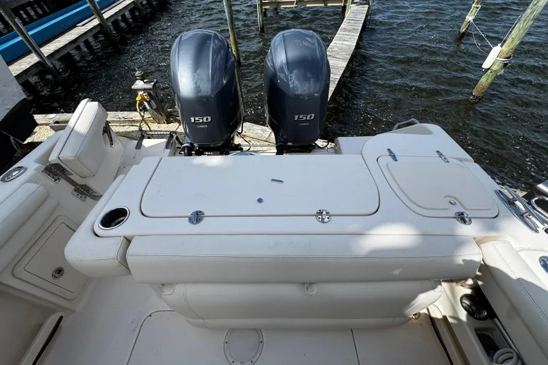 Slide: The Image of 2019 Grady-White Freedom 275 boat with twin Yamaha 150 engines docked by the water. - 27