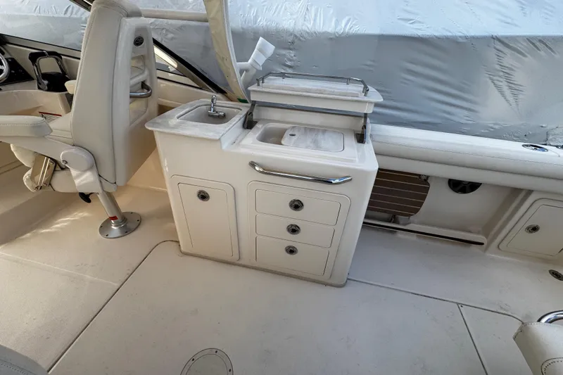 Slide: The Image of 2019 Grady-White Freedom 275 boat interior with sink and storage compartments. - 29