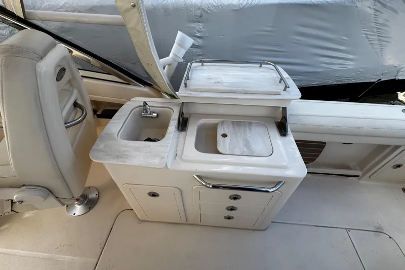 Slide: The Image of 2019 Grady-White Freedom 275 boat interior with sink and storage area. - 30