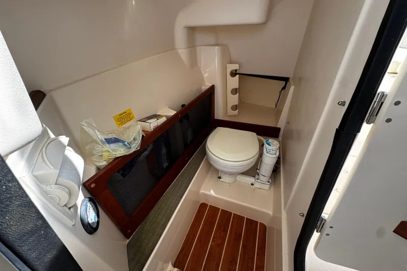 Slide: The Image of 2019 Grady-White Freedom 275 boat interior with compact marine toilet. - 37