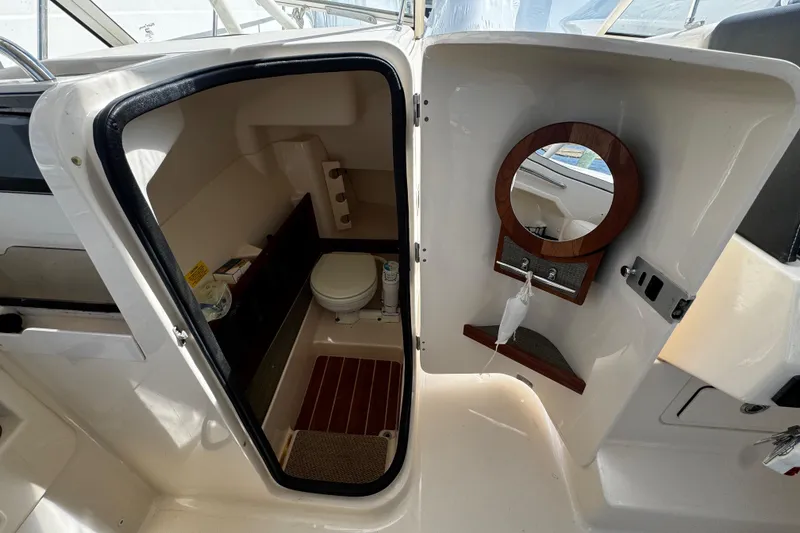 Slide: The Image of 2019 Grady-White Freedom 275 boat interior with compact bathroom and mirror. - 38