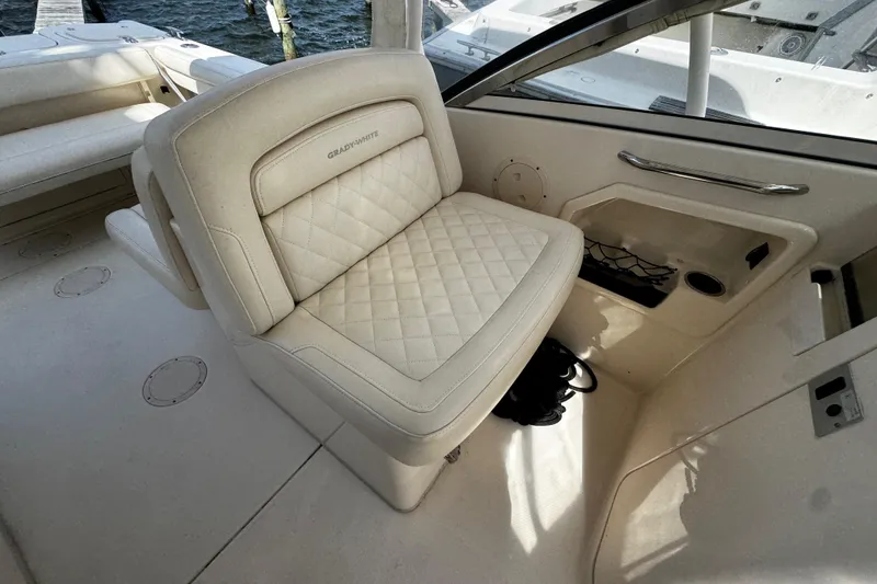 Slide: The Image of 2019 Grady-White Freedom 275 boat interior with cushioned seating and storage. - 39