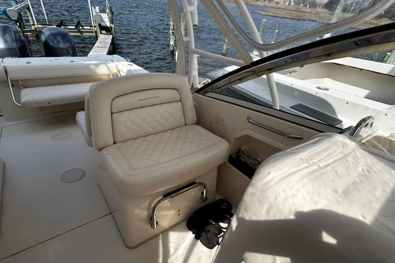 Slide: The Image of 2019 Grady-White Freedom 275 boat interior with plush seating and dual engines. - 43