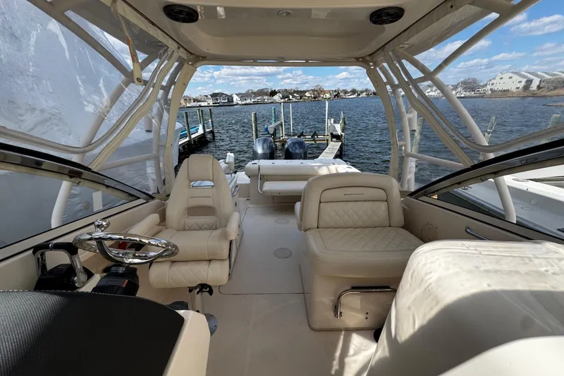 Slide: The Image of 2019 Grady-White Freedom 275 boat interior with luxurious seating and scenic waterfront view. - 45