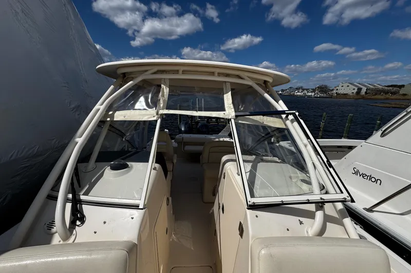 Slide: The Image of 2019 Grady-White Freedom 275 boat docked under a clear blue sky. - 46