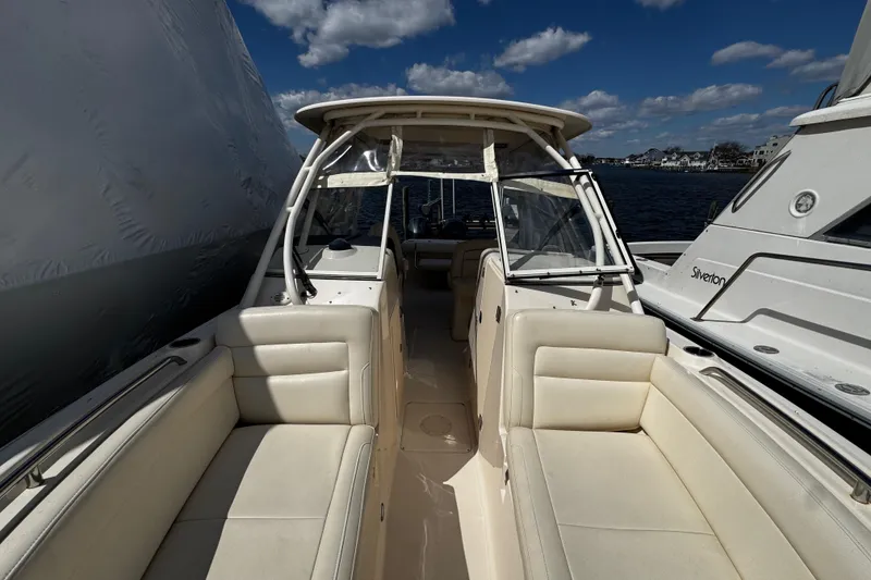 Slide: The Image of 2019 Grady-White Freedom 275 boat interior with beige seating and clear skies. - 47
