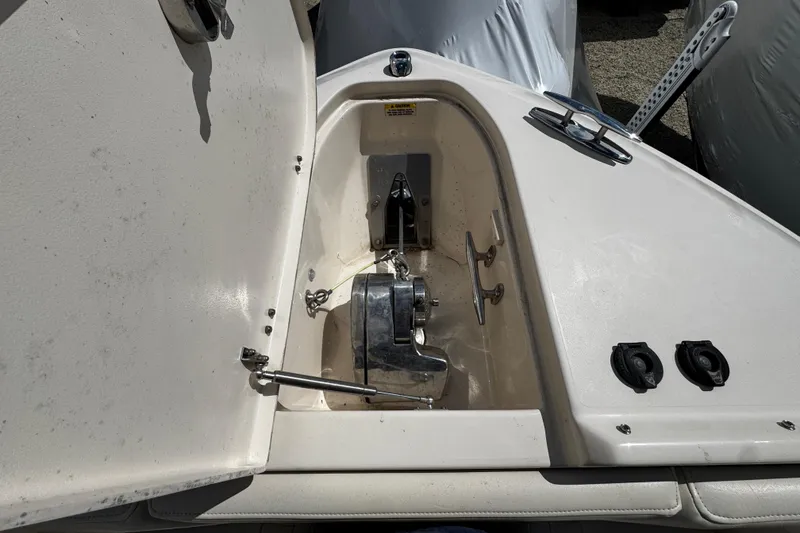 Slide: The Image of 2019 Grady-White Freedom 275 boat anchor compartment with open hatch and visible hardware. - 48