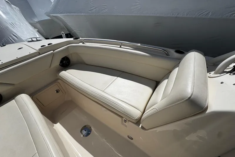 Slide: The Image of 2019 Grady-White Freedom 275 boat interior with beige seating and storage compartment. - 49