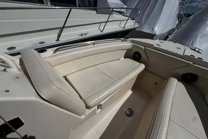 Slide: The Image of 2019 Grady-White Freedom 275 boat interior with cushioned seating and storage compartments. - 50