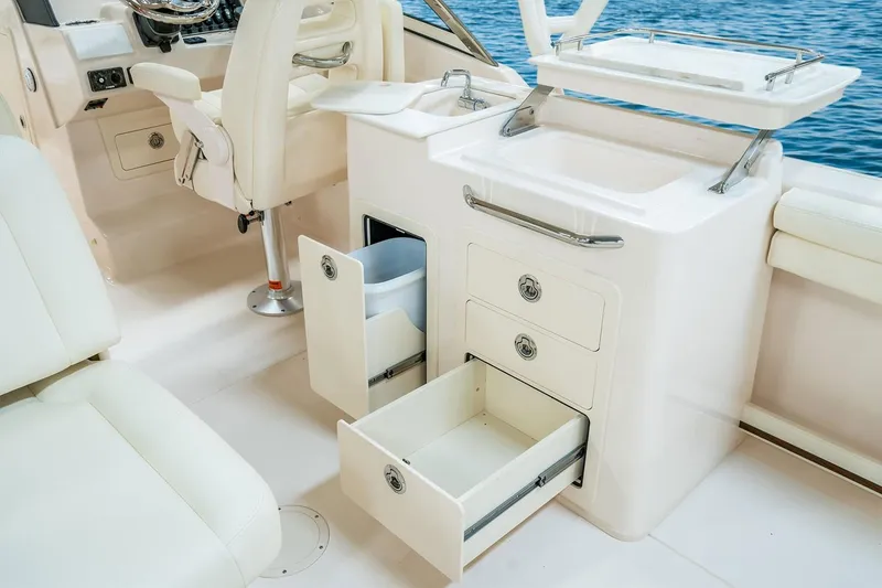 Slide: The Image of Manufacturer Provided Image: 2019 Grady-White Freedom 275 boat interior with storage compartments and sink. - 9
