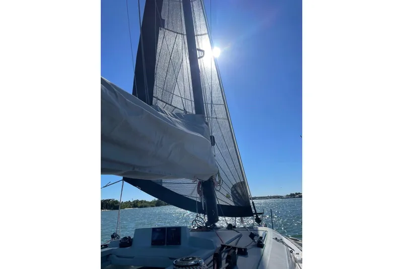 Slide: The Image of Sailing on a 2021 Corsair 880 Sport under clear blue skies. - 4