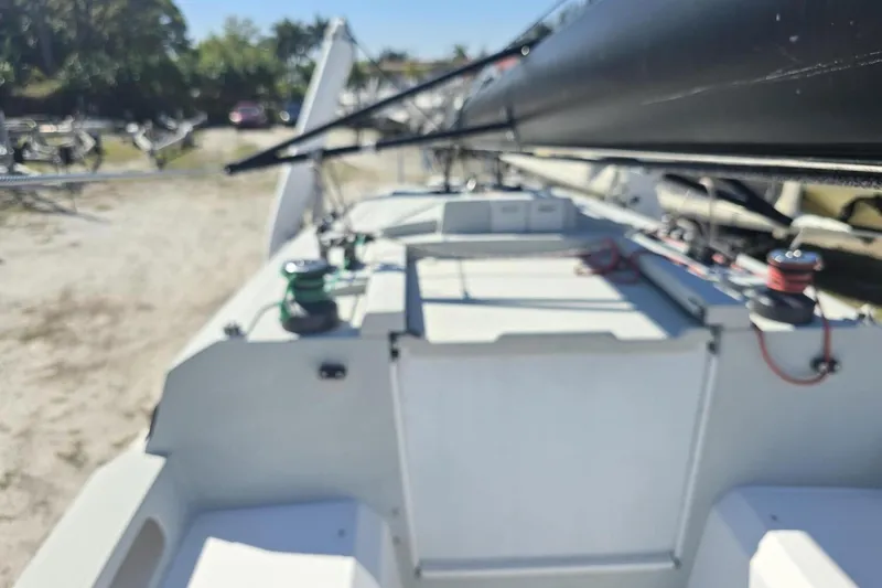 Slide: The Image of 2021 Corsair 880 Sport sailboat deck with rigging, docked outdoors. - 6