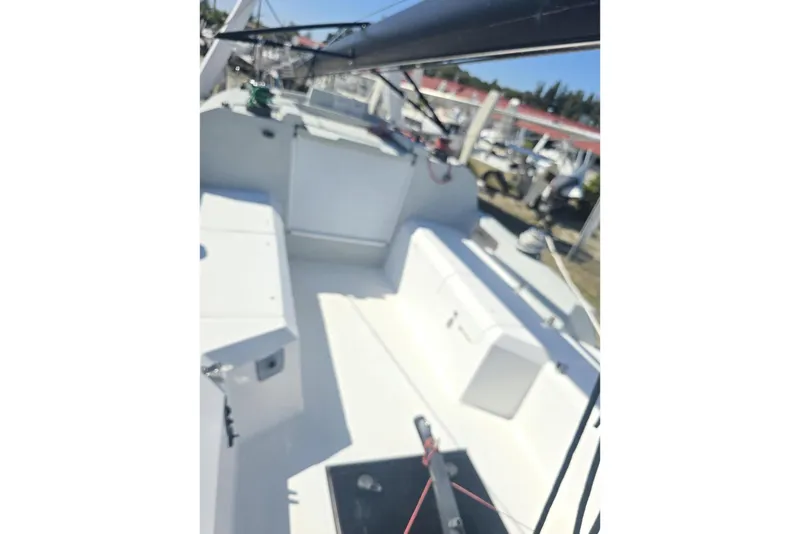 Slide: The Image of 2021 Corsair 880 Sport sailboat cockpit with white seating and rigging. - 8