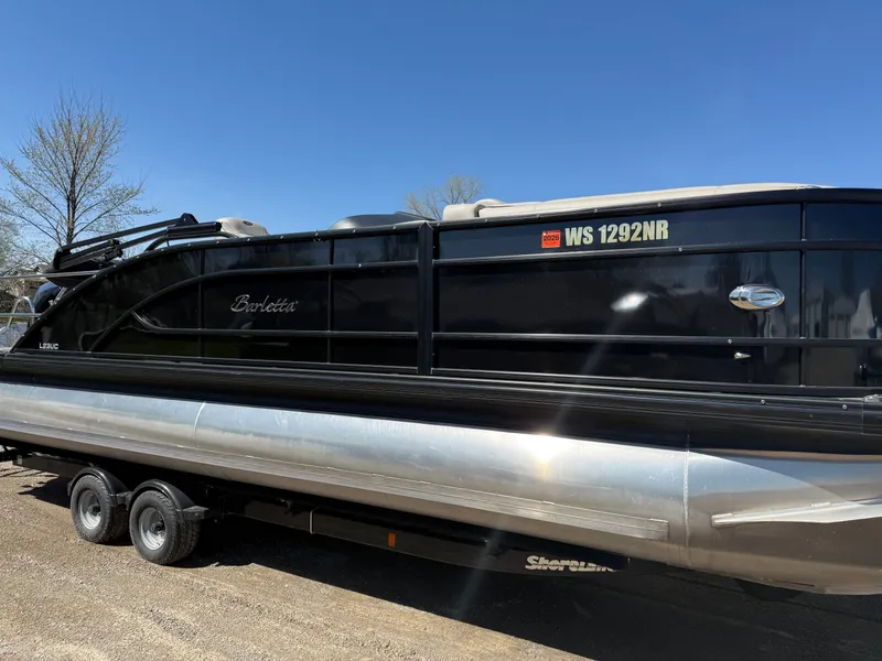 Slide: The Image of 2019 Barletta Lusso 23UC pontoon boat on trailer, blue sky. - 2