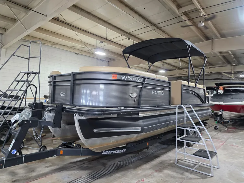 The Image of 2019 Harris 250 CR pontoon boat in a storage facility. - 0