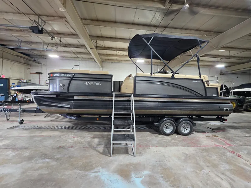 Slide: The Image of 2019 Harris 250 CR pontoon boat in a storage facility. - 1