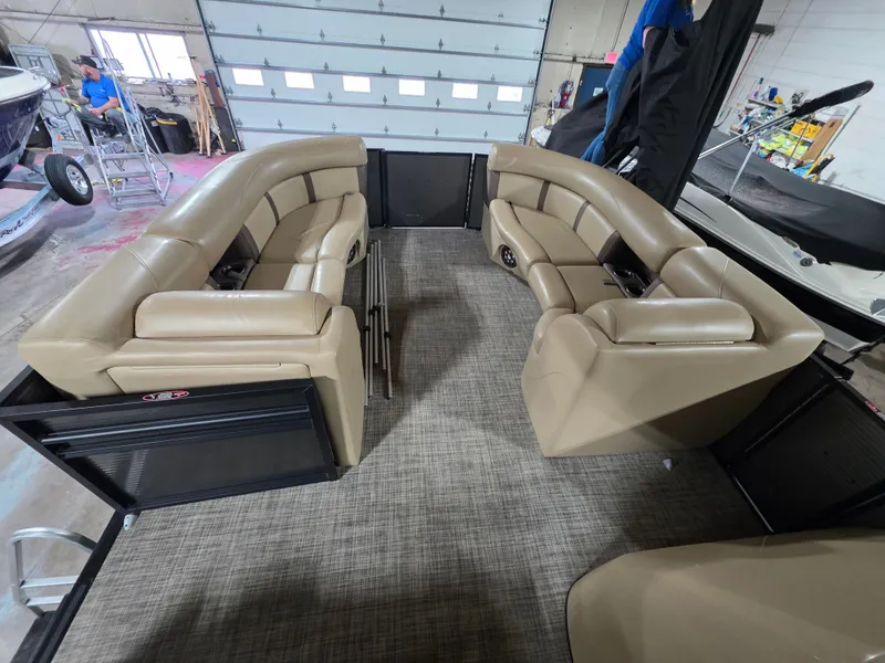 Slide: The Image of Interior of a 2019 Harris 250 CR pontoon boat with beige leather seating. - 14