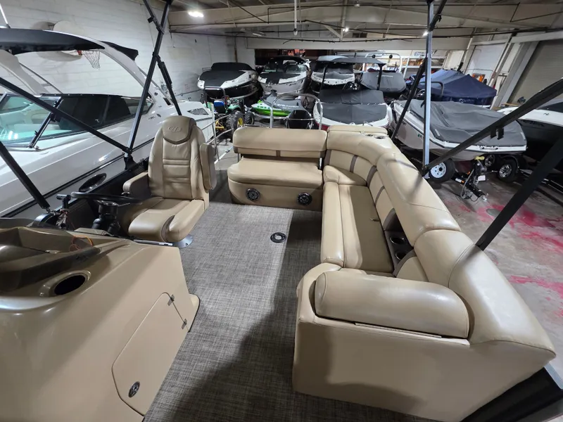 Slide: The Image of Interior of a 2019 Harris 250 CR pontoon boat in a warehouse. - 16