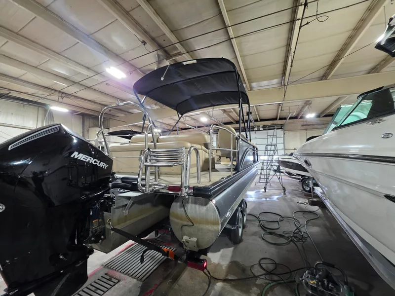 Slide: The Image of 2019 Harris 250 CR pontoon boat in a workshop. - 4