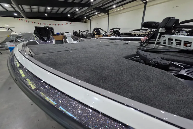 Slide: The Image of 2026 Skeeter boat with sleek design and spacious deck in showroom setting. - 10