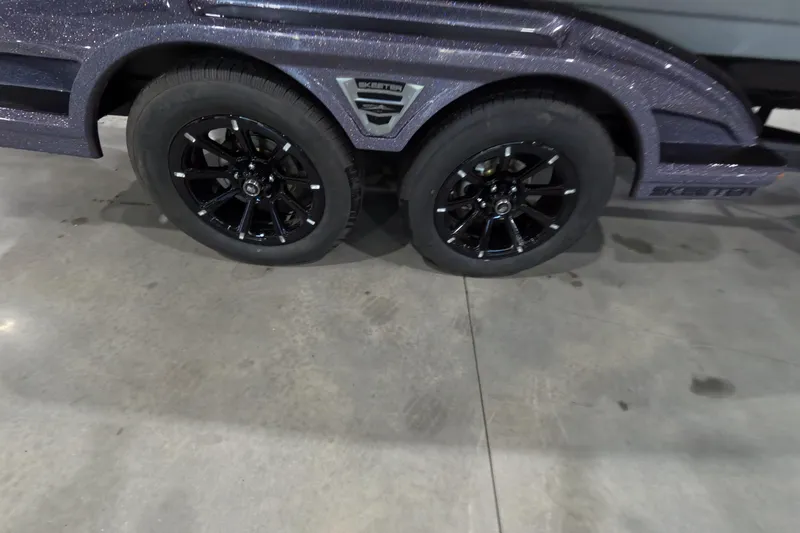 Slide: The Image of 2026 Skeeter vehicle with dual black alloy wheels on a concrete surface. - 15