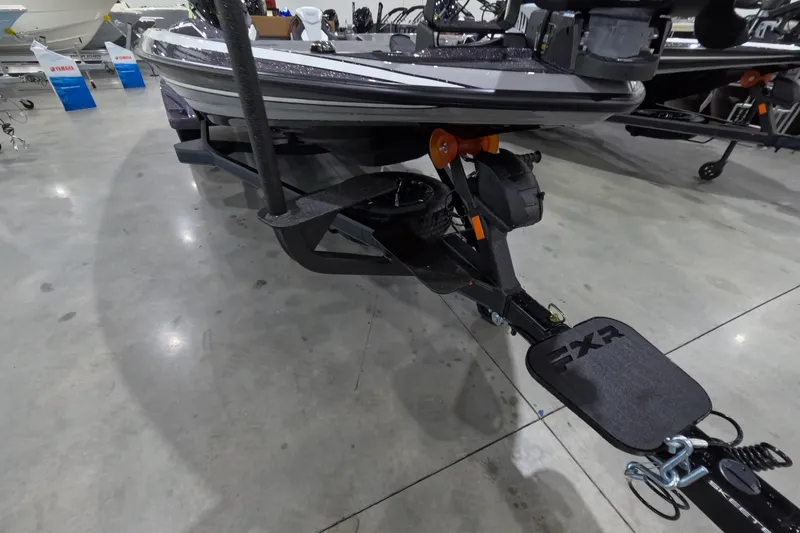 Slide: The Image of 2026 Skeeter boat trailer with FXR branding in a showroom setting. - 8