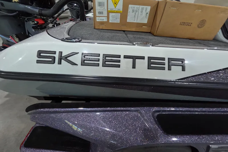 Slide: The Image of 2026 Skeeter boat with logo, featuring a sleek design and cardboard boxes on deck. - 14