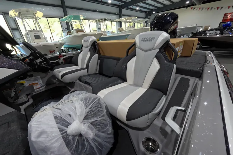 Slide: The Image of 2026 Skeeter boat interior with modern seating and steering wheel in showroom. - 4