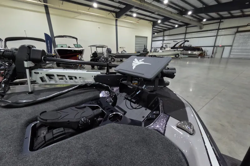 Slide: The Image of 2026 Skeeter boat interior with advanced navigation system in a spacious showroom. - 9