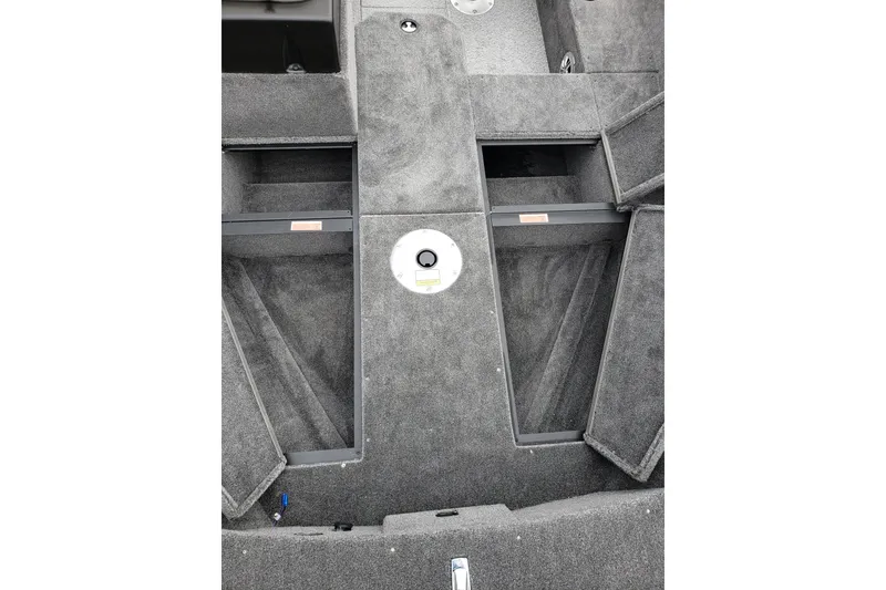 Slide: The Image of 2026 Alumacraft Voyageur 175 SC boat interior with carpeted storage compartments. - 11