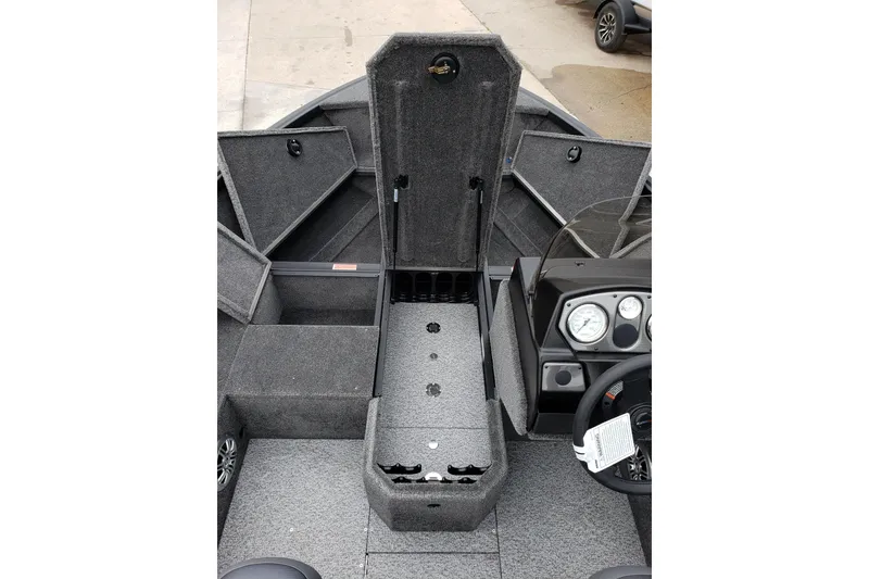 Slide: The Image of 2026 Alumacraft Voyageur 175 SC boat interior with storage compartments and dashboard. - 12