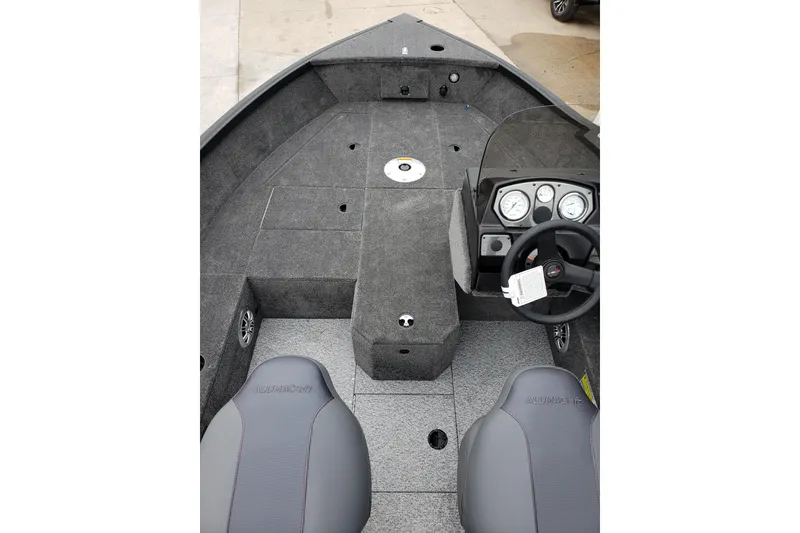 Slide: The Image of 2026 Alumacraft Voyageur 175 SC boat interior with steering console and seating. - 14