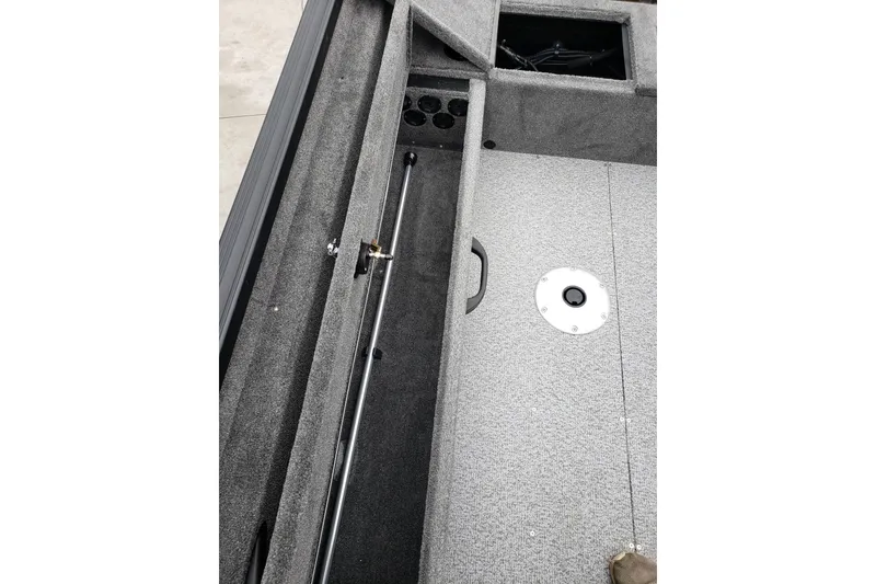 Slide: The Image of 2026 Alumacraft Voyageur 175 SC boat interior with storage compartments and rod holder. - 15