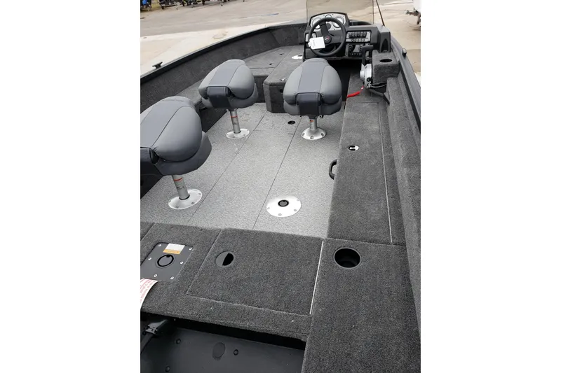 Slide: The Image of 2026 Alumacraft Voyageur 175 SC boat interior with seating and steering console. - 6