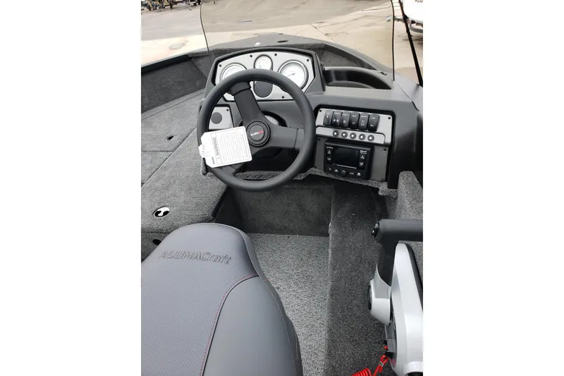Slide: The Image of Interior view of 2026 Alumacraft Voyageur 175 SC boat dashboard and steering. - 7