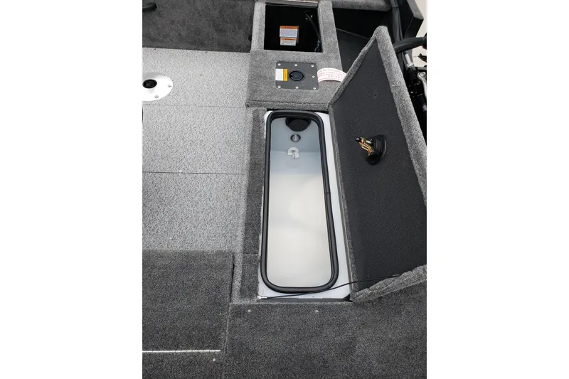 Slide: The Image of 2026 Alumacraft Voyageur 175 SC boat interior with open storage compartment. - 8