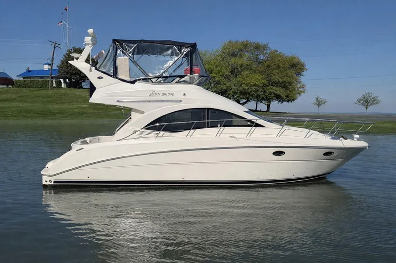 The Image of 2007 Sea Ray 36 Sedan Bridge yacht on calm water, side view. - 0