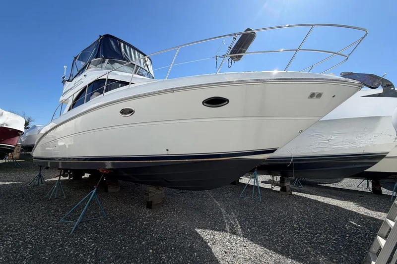 The Image of 2007 Sea Ray 36 Sedan Bridge yacht on stands, under clear blue sky. - 1