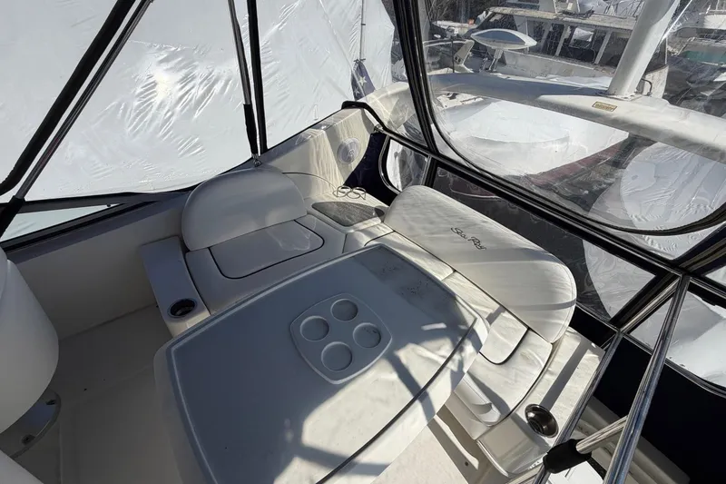 Slide: The Image of 2007 Sea Ray 36 Sedan Bridge interior with seating and table, enclosed by clear panels. - 15