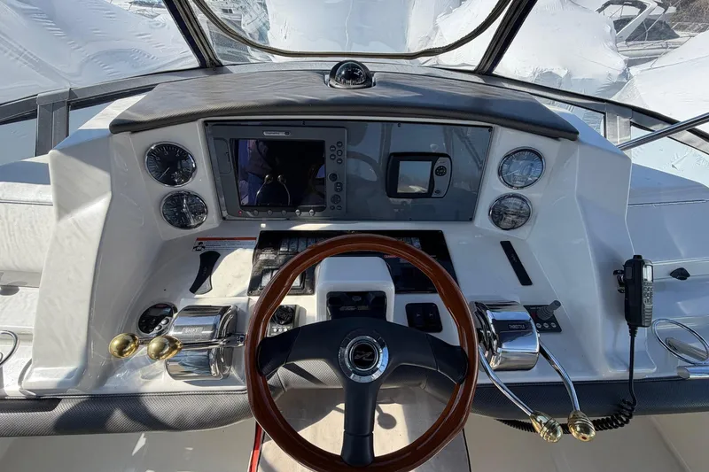 Slide: The Image of 2007 Sea Ray 36 Sedan Bridge helm with steering wheel, gauges, and navigation equipment. - 16