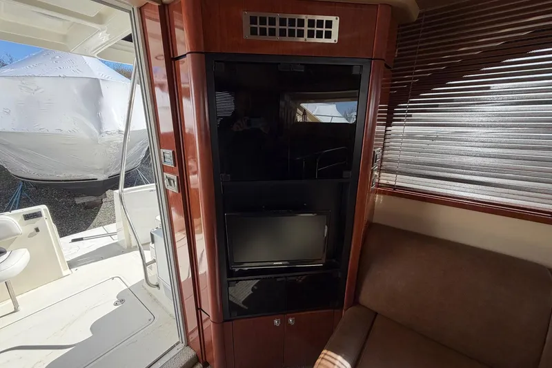 Slide: The Image of Interior of 2007 Sea Ray 36 Sedan Bridge with TV and seating area. - 24