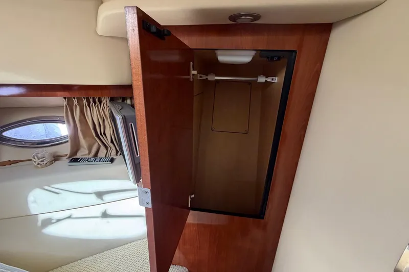 Slide: The Image of Open wooden cabinet inside 2007 Sea Ray 36 Sedan Bridge yacht interior. - 28