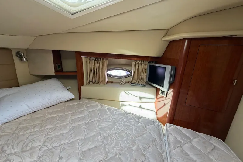 Slide: The Image of Luxurious cabin interior of 2007 Sea Ray 36 Sedan Bridge yacht with bed and TV. - 29